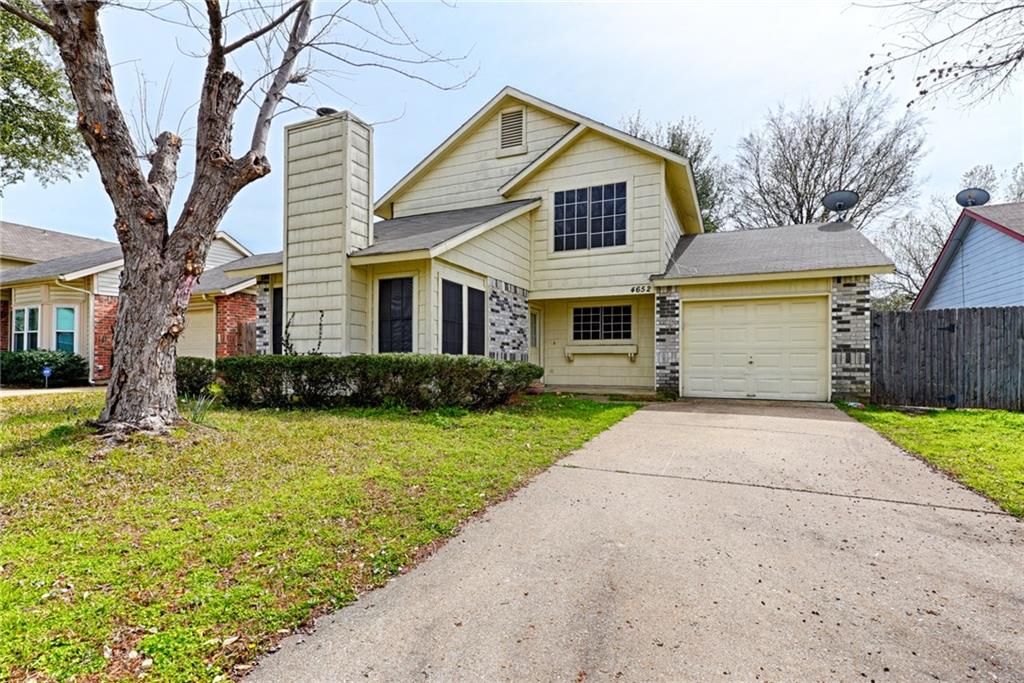 4652 Misty Ridge Drive Fort Worth, TX 76137 - Photo 2 of 24 a front view of a house with a yard and garage