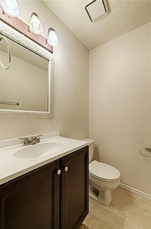 a bathroom with a sink a toilet and mirror