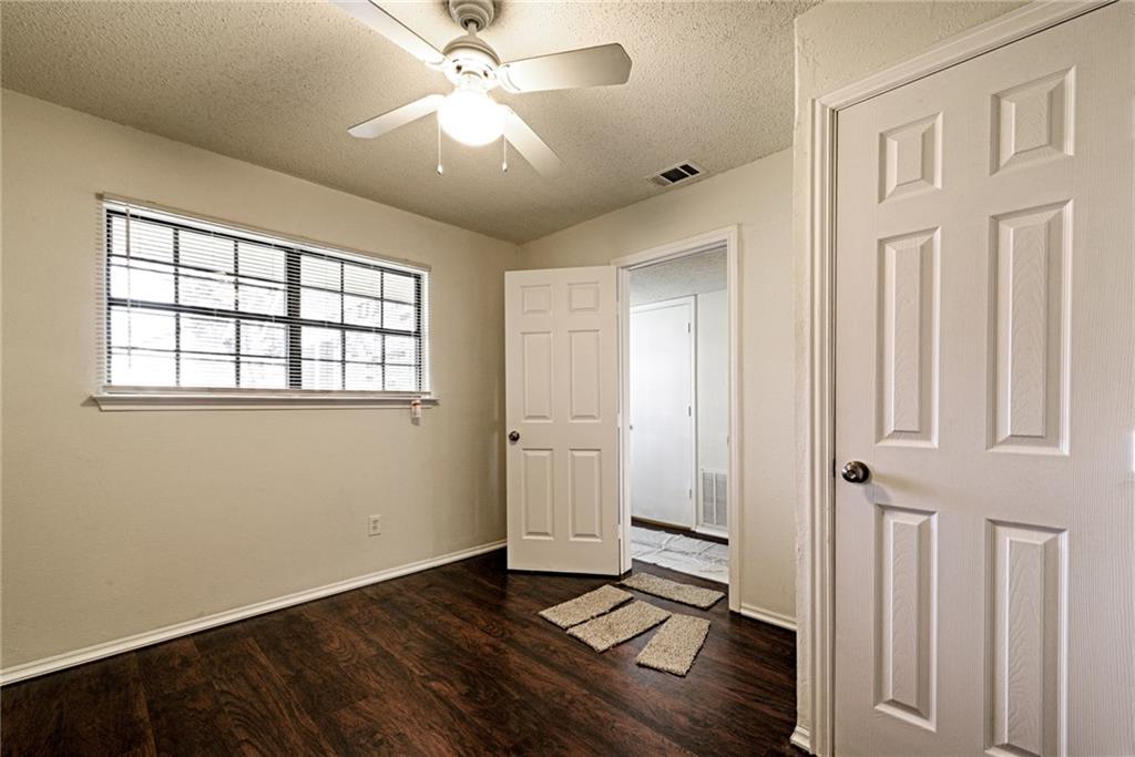 4652 Misty Ridge Drive Fort Worth, TX 76137 - Photo 7 of 24 wooden floor in an empty room with a window