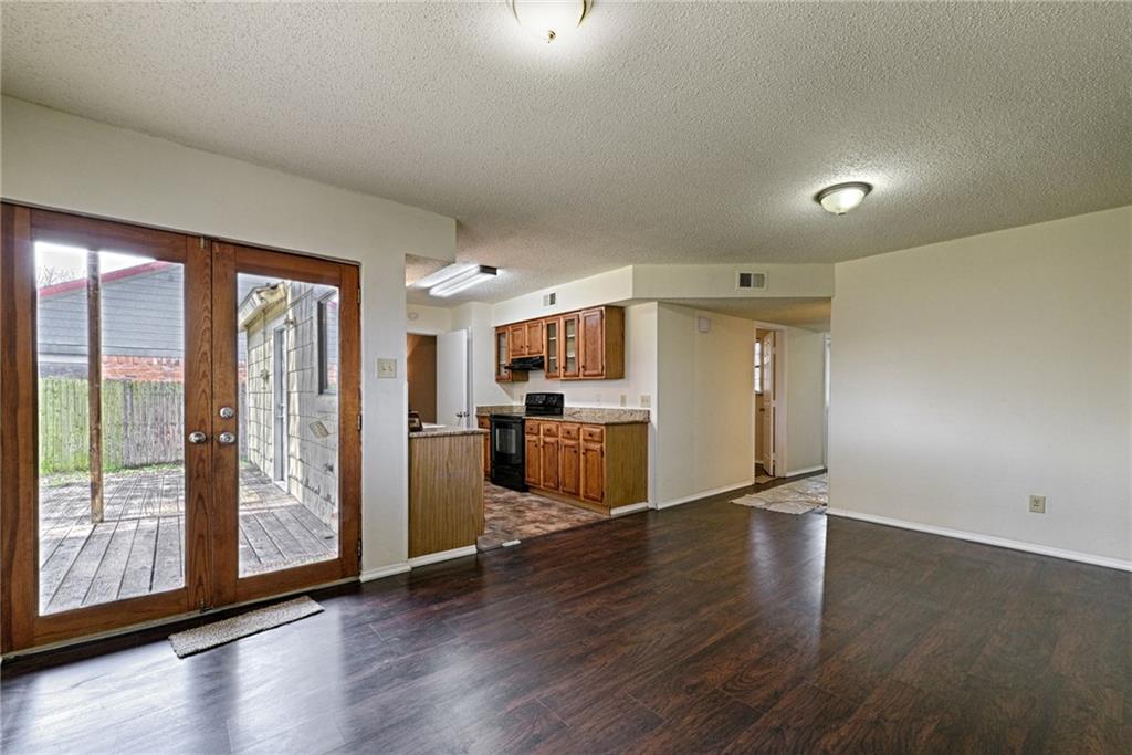 4652 Misty Ridge Drive Fort Worth, TX 76137 - Photo 9 of 24 a view of a kitchen with refrigerator and wooden floor