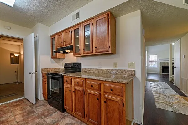 a kitchen with stainless steel appliances granite countertop a stove and a sink