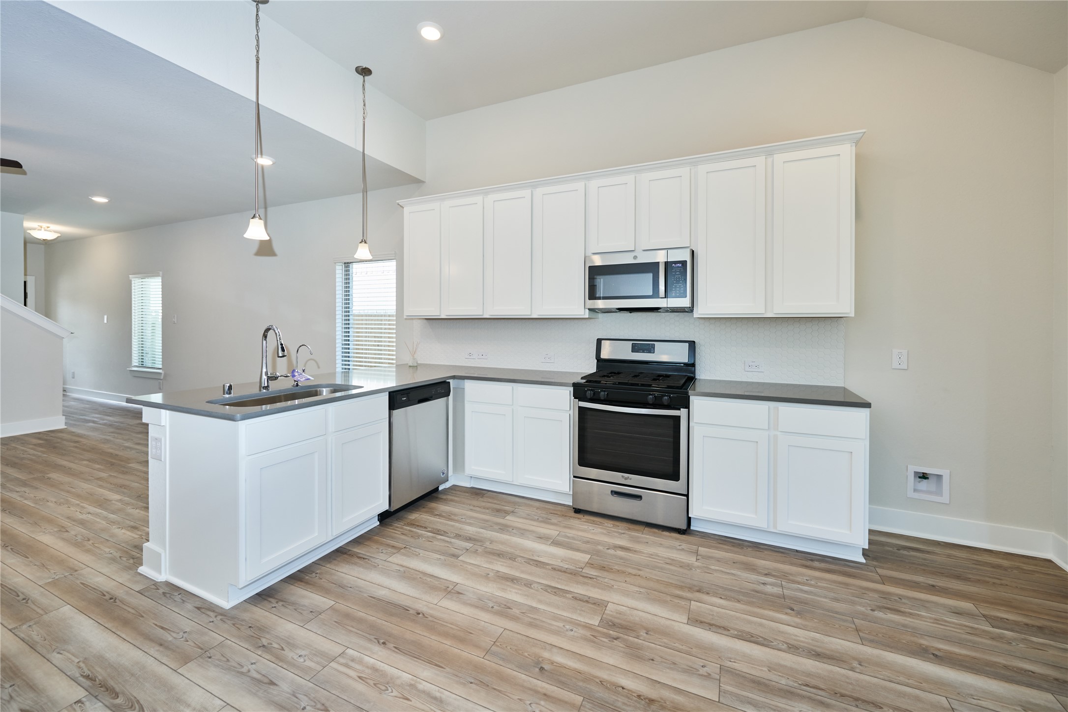 10647 Whitejacket Conroe, TX 77385 - Photo 14 of 38 a kitchen with stainless steel appliances white cabinets and a wooden floors