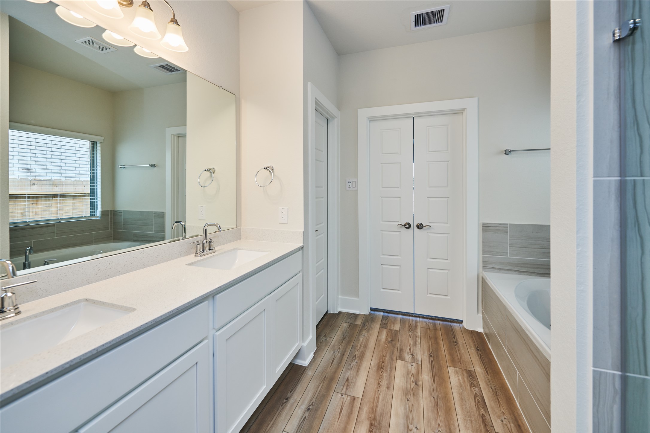 10647 Whitejacket Conroe, TX 77385 - Photo 21 of 38 a view of bathroom with a sink mirror and shower