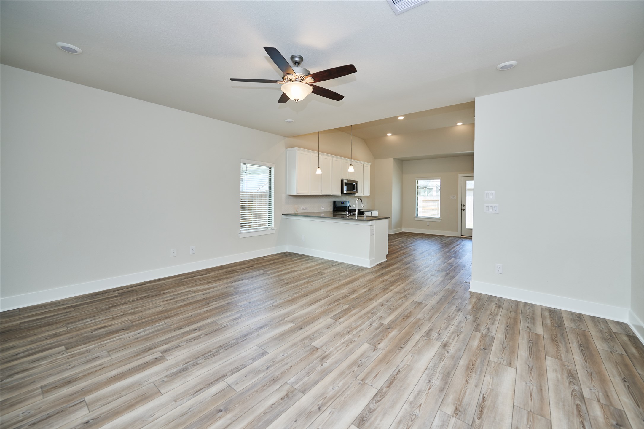 10647 Whitejacket Conroe, TX 77385 - Photo 8 of 38 a view of a kitchen with a sink and a stove top oven