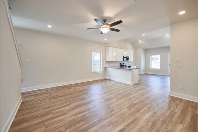 a view of a kitchen with wooden floor and a kitchen