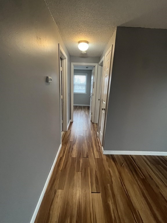 1475 Braley Road, Unit 21 New Bedford, MA 02745 - Photo 11 of 18 a view of a hallway with wooden floor
