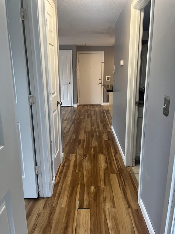 1475 Braley Road, Unit 21 New Bedford, MA 02745 - Photo 14 of 18 a view of a hallway view with wooden floor and staircase