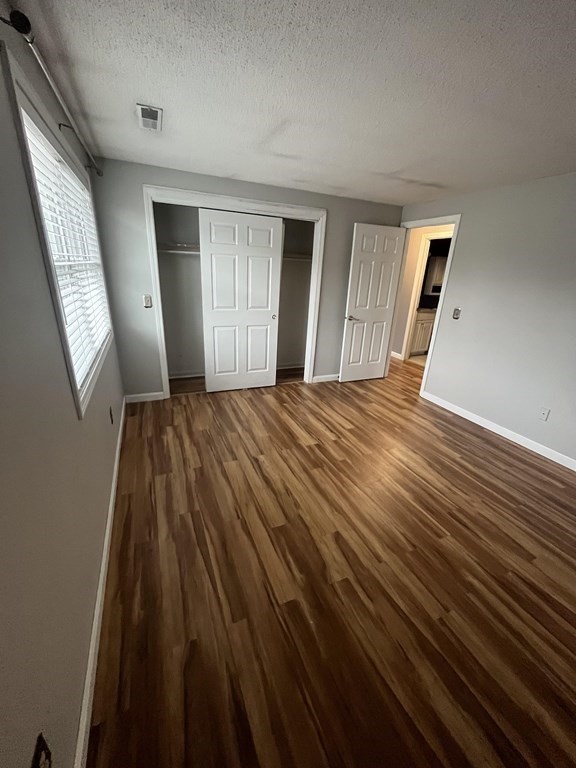1475 Braley Road, Unit 21 New Bedford, MA 02745 - Photo 16 of 18 a bedroom with a bed and wooden floor