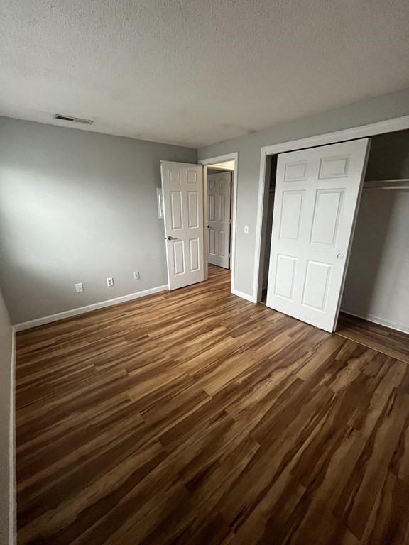 1475 Braley Road, Unit 21 New Bedford, MA 02745 - Photo 18 of 18 a view of empty room with wooden floor