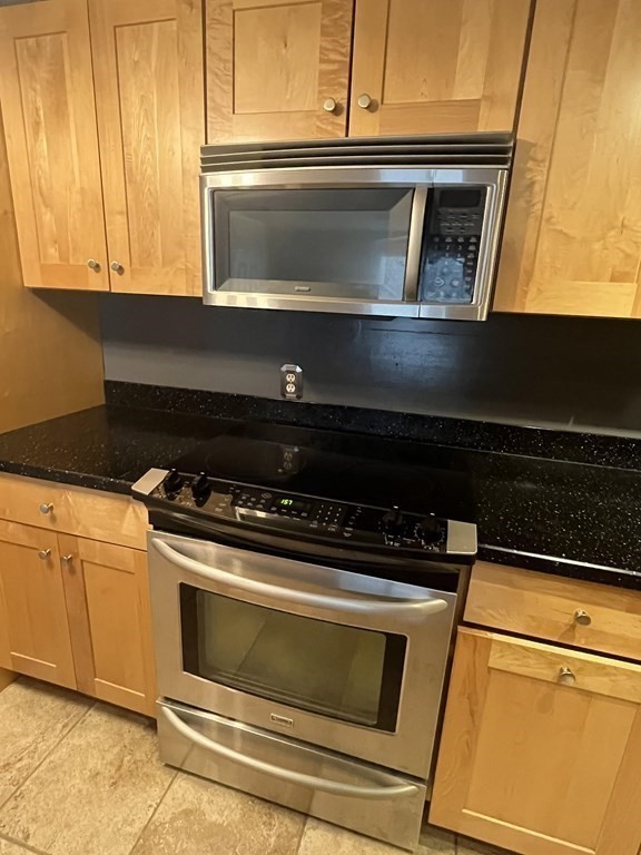 1475 Braley Road, Unit 21 New Bedford, MA 02745 - Photo 8 of 18 a stove top oven sitting inside of a kitchen
