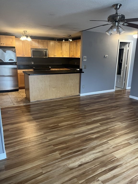 1475 Braley Road, Unit 21 New Bedford, MA 02745 - Photo 9 of 18 an empty room with wooden floor and windows