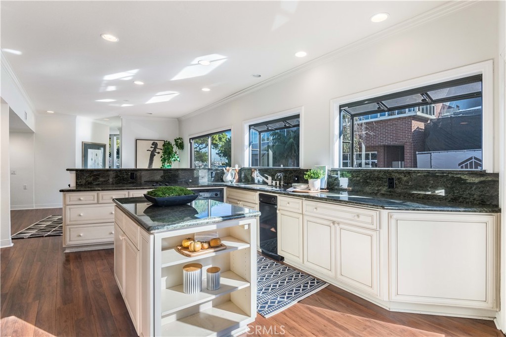 6090 Appian Way Long Beach, CA 90803 - Photo 11 of 41 a kitchen with stainless steel appliances granite countertop a sink stove and cabinets