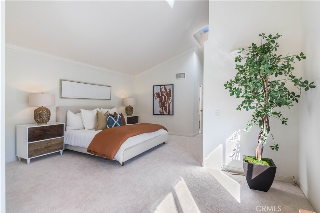6090 Appian Way Long Beach, CA 90803 - Photo 20 of 41 a bedroom with a bed and a potted plant