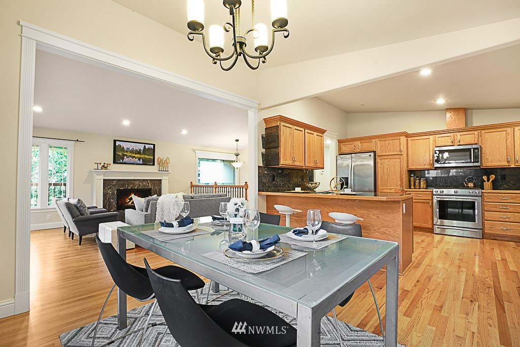 2806 183rd Avenue Northeast Redmond, WA 98052 - Photo 15 of 40 a view of a dining room with furniture a kitchen and chandelier