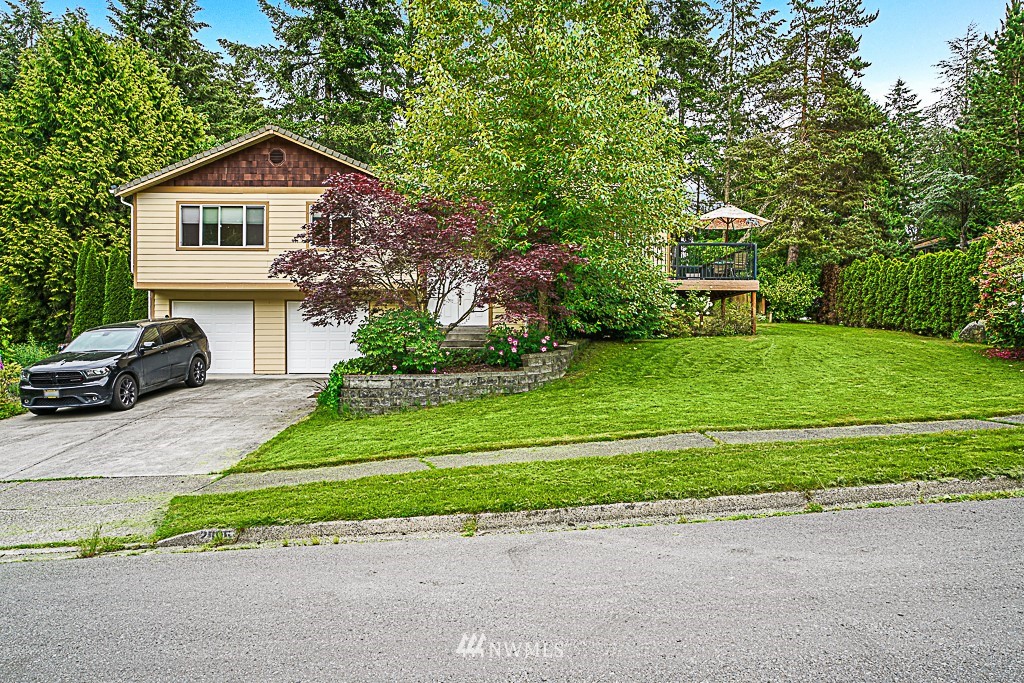 2806 183rd Avenue Northeast Redmond, WA 98052 - Photo 4 of 40 a front view of a house with a yard and garage