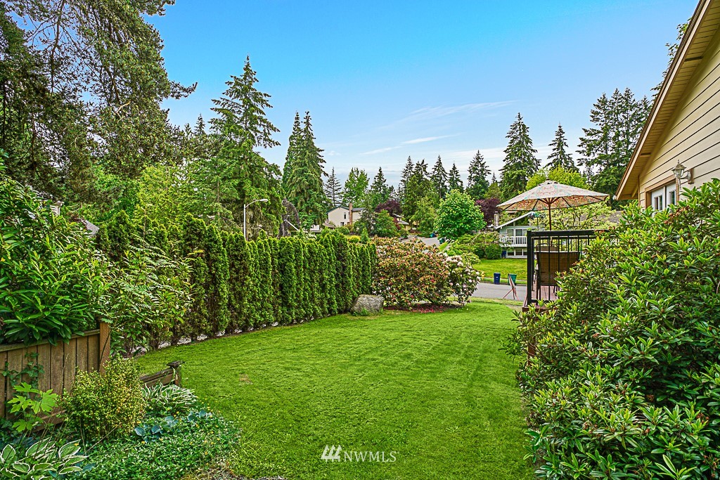 2806 183rd Avenue Northeast Redmond, WA 98052 - Photo 7 of 40 a backyard of a house with lots of green space and fountain