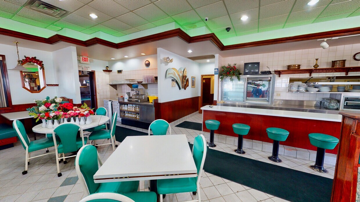 900 North Union Street Dwight, IL 60420 - Photo 10 of 13 a kitchen with stainless steel appliances kitchen island granite countertop a dining table chairs and a wooden floor