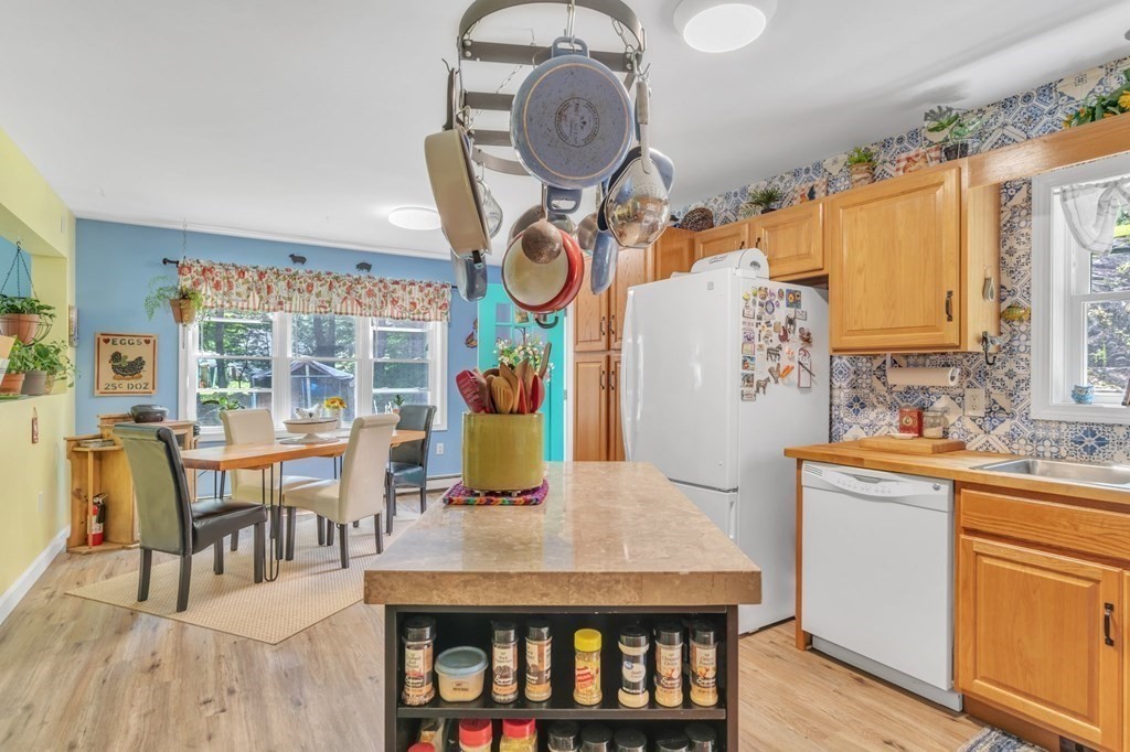 359 March Road Ashfield, MA 01370 - Photo 13 of 34 a kitchen with stainless steel appliances granite countertop a stove a sink dishwasher and white cabinets with wooden floor