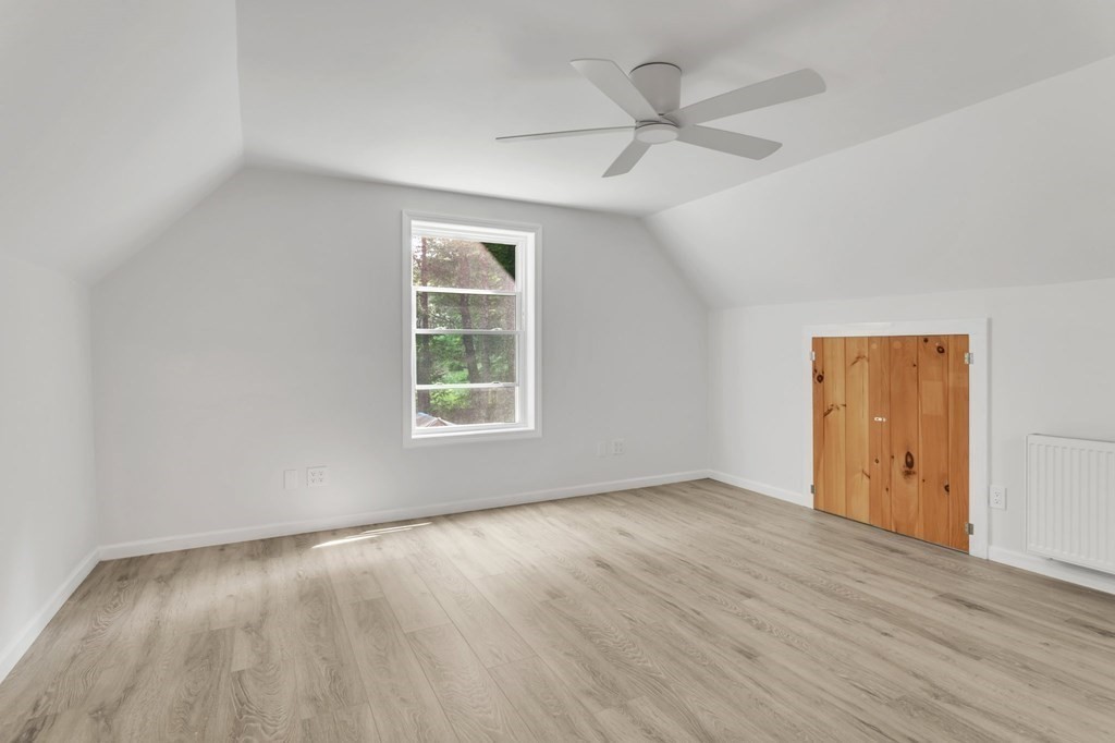 359 March Road Ashfield, MA 01370 - Photo 24 of 34 an empty room with wooden floor ceiling fan and windows