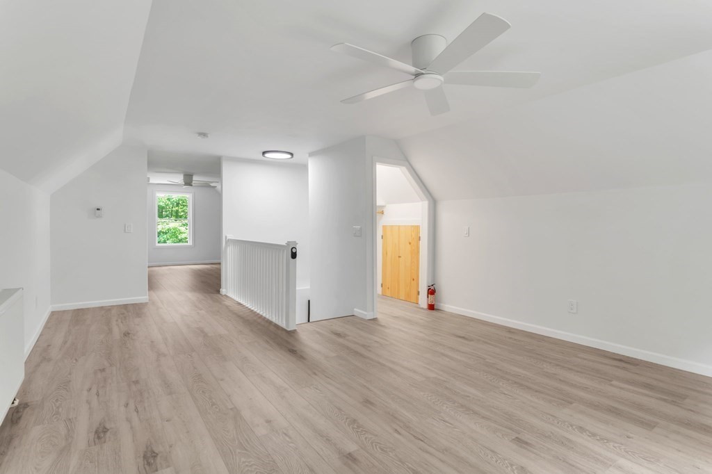 359 March Road Ashfield, MA 01370 - Photo 25 of 34 an empty room with wooden floor and windows