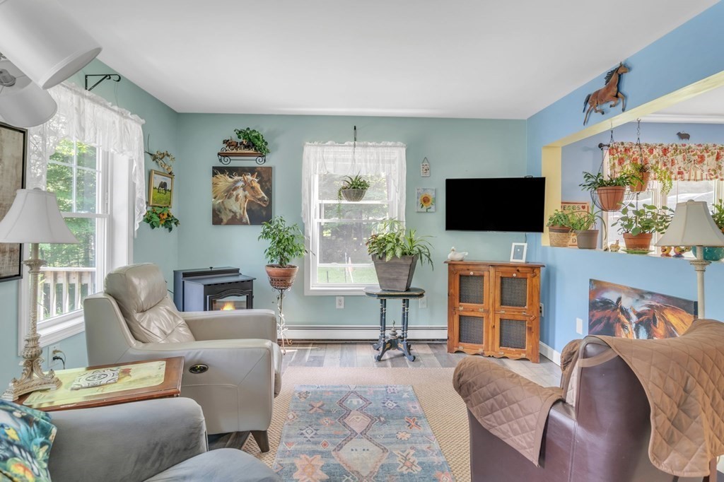 359 March Road Ashfield, MA 01370 - Photo 7 of 34 a living room with furniture a flat screen tv and a fireplace