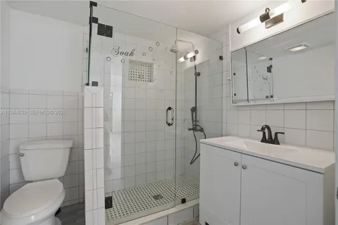 a bathroom with a shower a toilet and sink