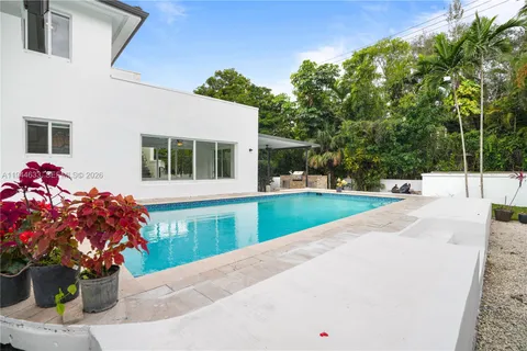 a view of a house with a yard and sitting area