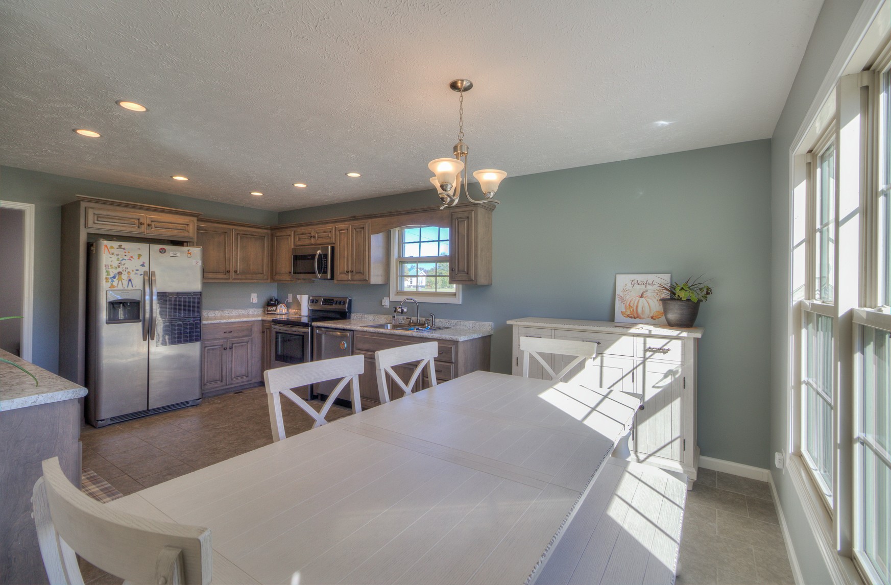 869 Jarrell Road Manchester, TN 37355 - Photo 7 of 33 a dining room with wooden floor a chandelier a wooden table and chairs