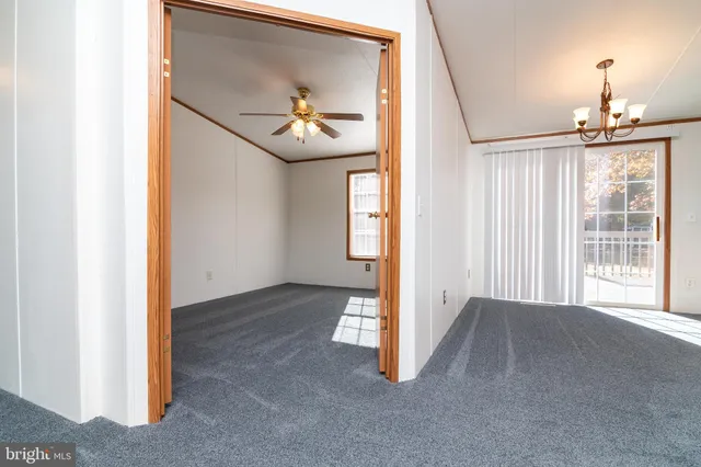 a view of a room with wooden floor and windows