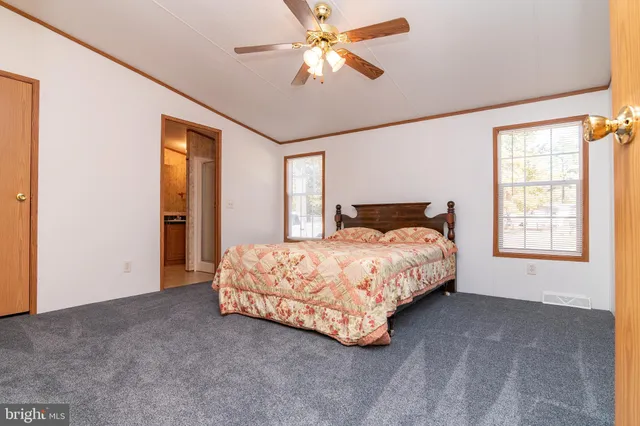 a spacious bedroom with a bed and a chandelier
