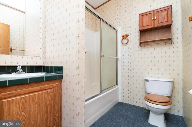 a bathroom with a toilet a sink and a shower