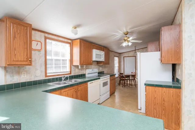 a large kitchen with lots of counter top space and stainless steel appliances