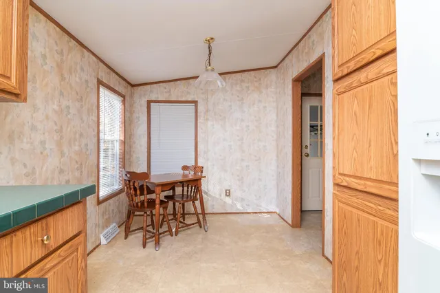a dining room with furniture and a window
