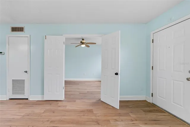 a view of room with window and ceiling fan