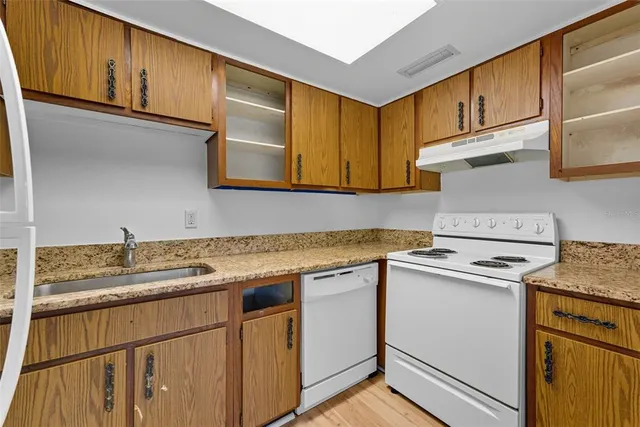 a view of a room with wooden floor and a window