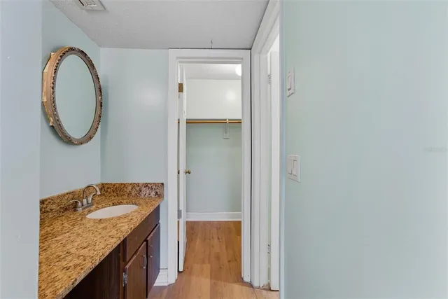 a bathroom with a granite countertop sink and vanity
