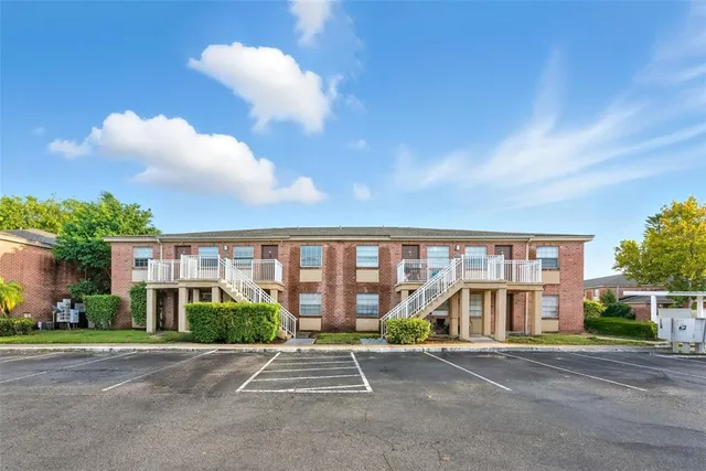 a view of a room with wooden floor and a ceiling fan