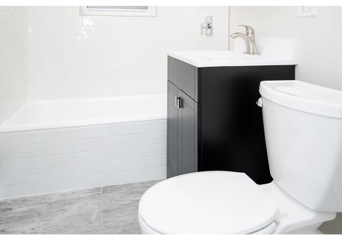 648 West Roscoe Street, Unit 2N Chicago, IL 60657 - Photo 12 of 12 a bathroom with a sink toilet and vanity