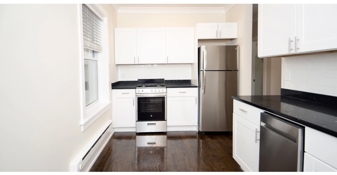 648 West Roscoe Street, Unit 2N Chicago, IL 60657 - Photo 4 of 12 a kitchen with a stove a refrigerator and a stove