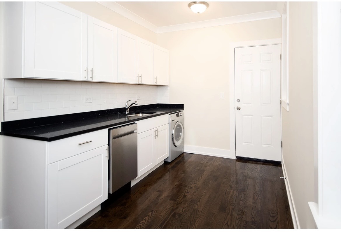 648 West Roscoe Street, Unit 2N Chicago, IL 60657 - Photo 5 of 12 a kitchen with granite countertop white cabinets and white appliances