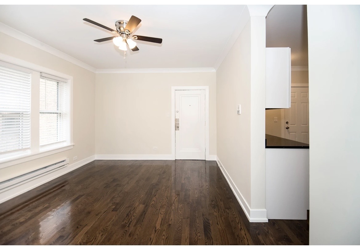 648 West Roscoe Street, Unit 2N Chicago, IL 60657 - Photo 9 of 12 a view of a workspace with wooden floor and a ceiling fan