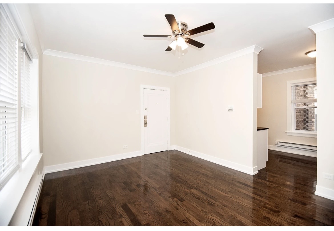 648 West Roscoe Street, Unit 2N Chicago, IL 60657 - Photo 10 of 12 wooden floor in an empty room with a window