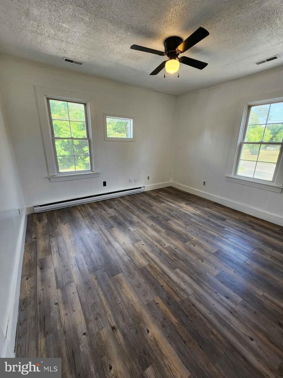 26530 Three Notch Road, Unit 1 Mechanicsville, MD 20659 - Photo 2 of 9 wooden floor in an empty room with a window