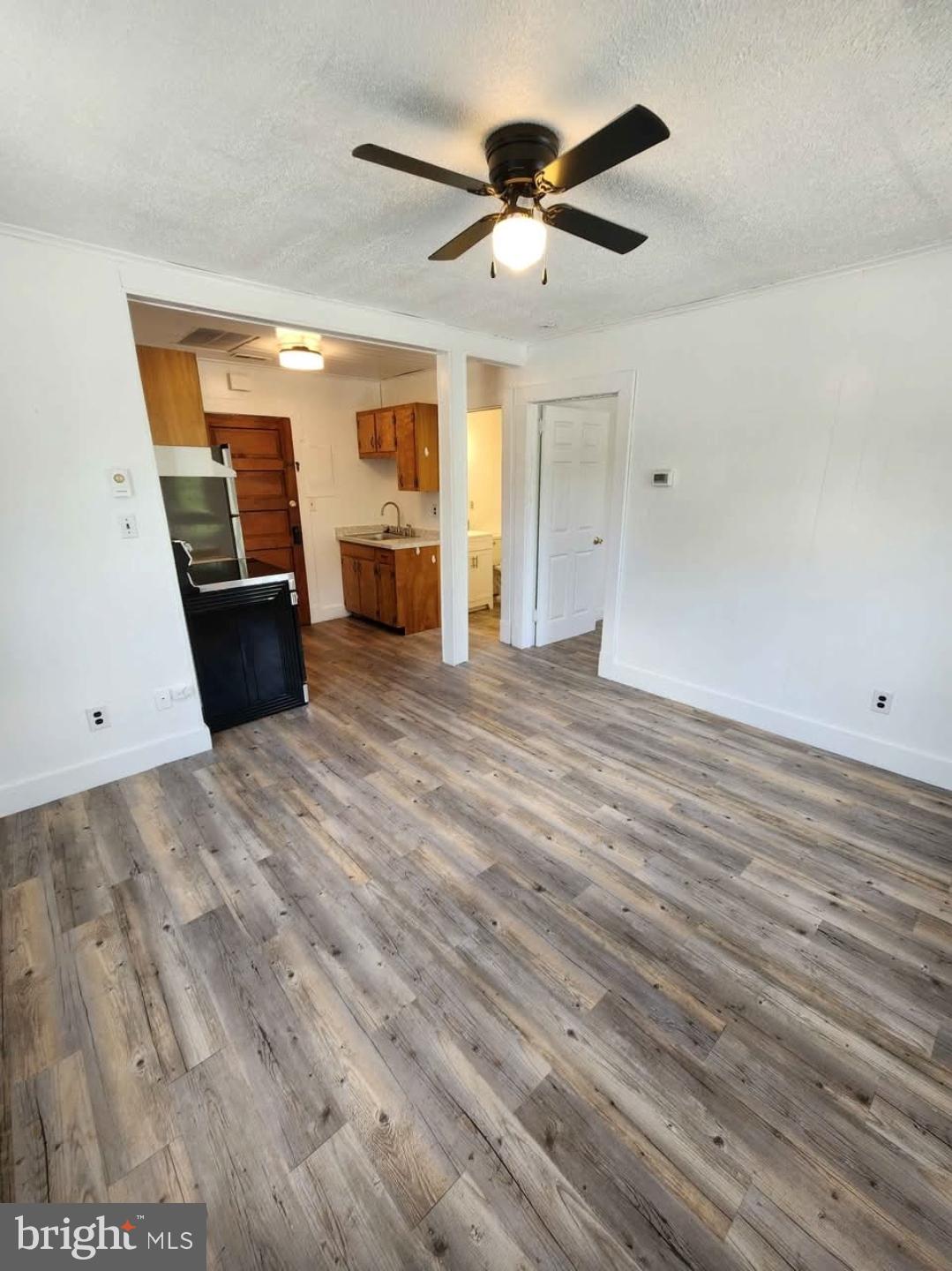 26530 Three Notch Road, Unit 1 Mechanicsville, MD 20659 - Photo 3 of 9 wooden floor in an empty room with a window