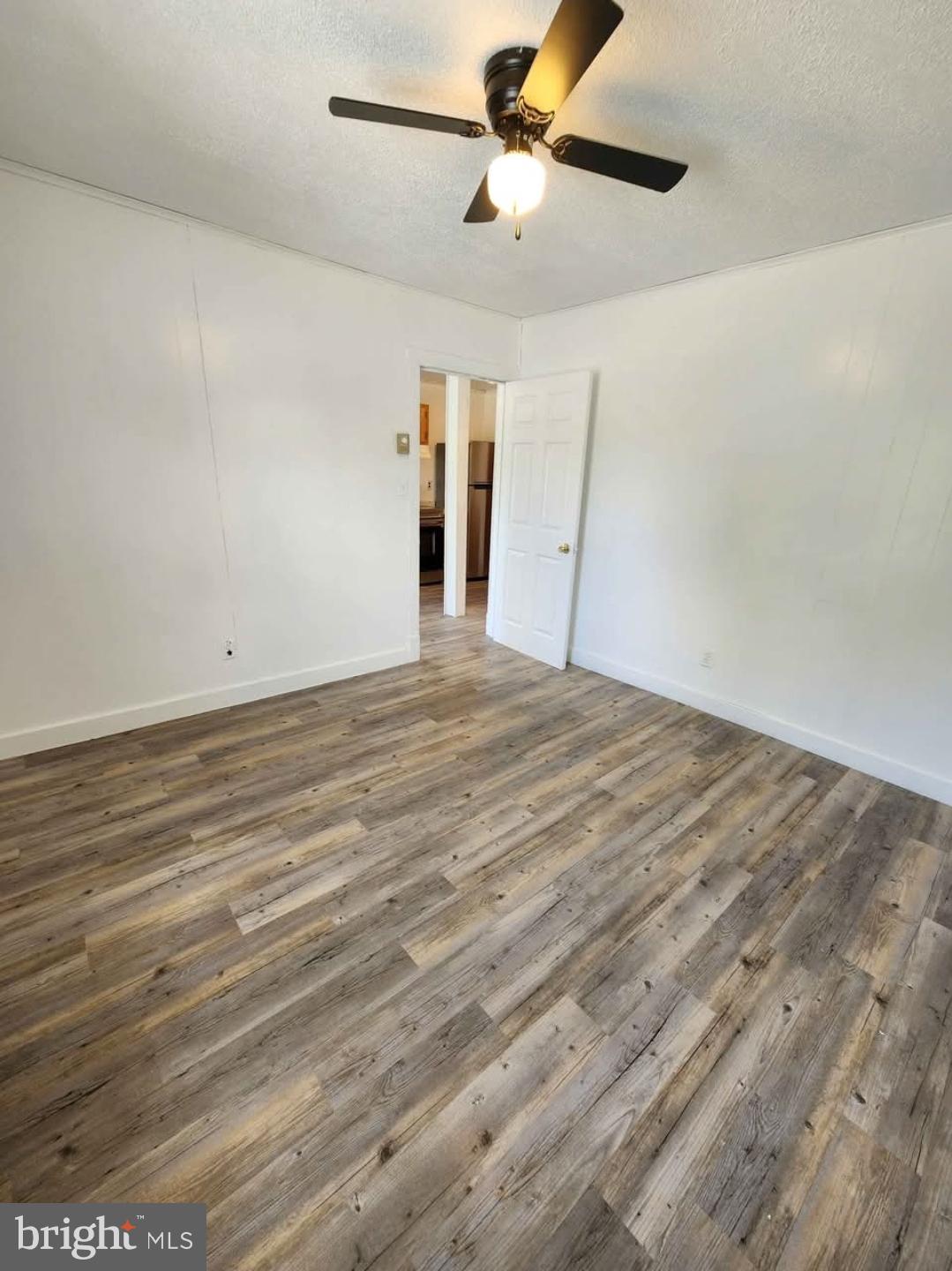 26530 Three Notch Road, Unit 1 Mechanicsville, MD 20659 - Photo 5 of 9 a view of empty room with wooden floor