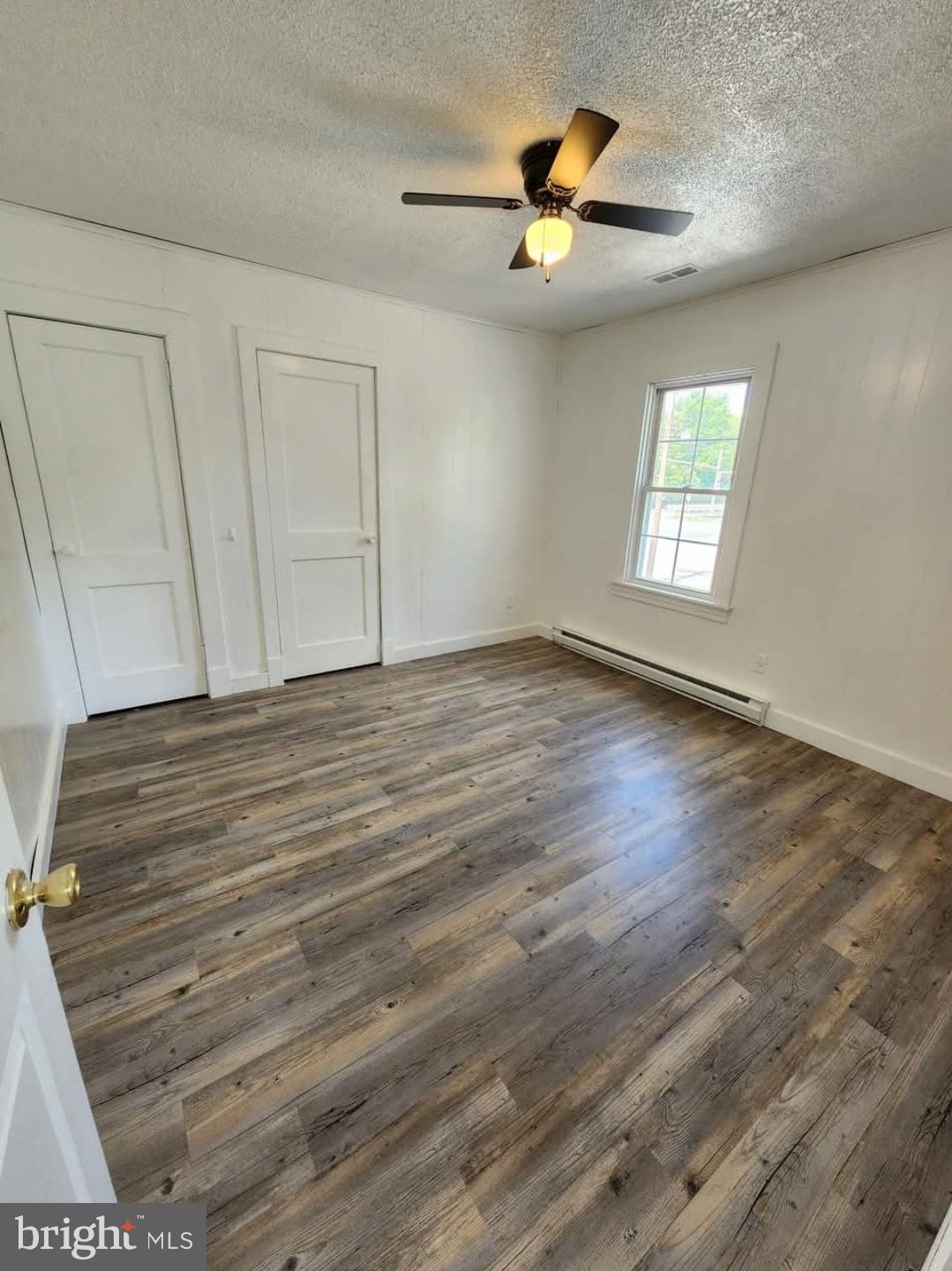 26530 Three Notch Road, Unit 1 Mechanicsville, MD 20659 - Photo 6 of 9 wooden floor in an empty room with a window