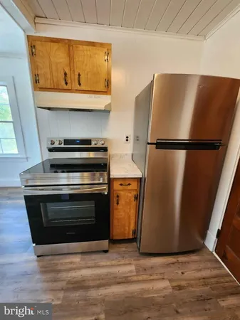 a view of a kitchen with a refrigerator a sink and a stove