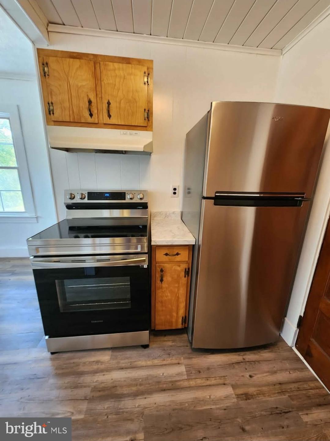26530 Three Notch Road, Unit 1 Mechanicsville, MD 20659 - Photo 8 of 9 a view of a kitchen with a refrigerator a sink and a stove