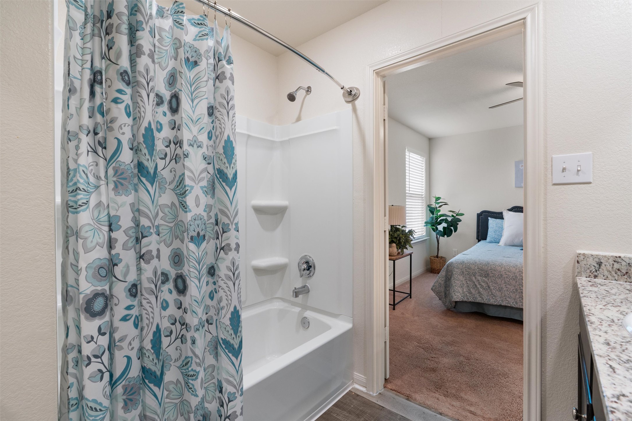 163 Niven Path, Unit 12K Jarrell, TX 76537 - Photo 19 of 31 a en suite bathroom with a bathtub and a shower