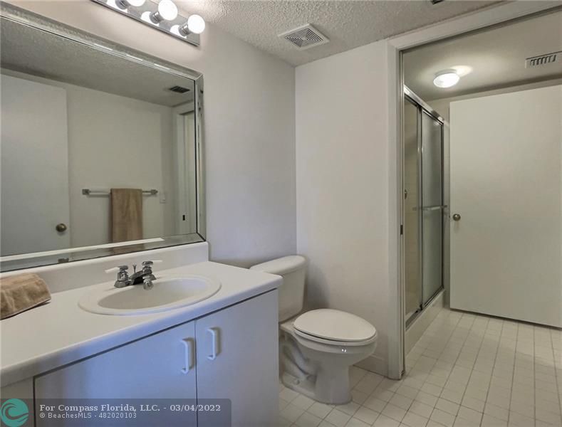 9537 Weldon Circle, Unit I308 Tamarac, FL 33321 - Photo 6 of 12 a bathroom with a sink a toilet and shower